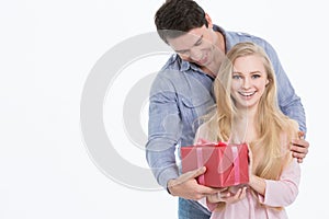 Happy Man giving a gift to his Girlfriend. Holiday
