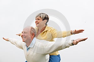 Happy man giving piggyback to woman