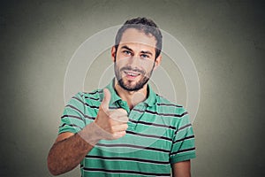 Happy man giving thumbs up sign. Positive human face expression body language