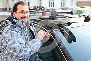 Happy man in glasses with mobile phone in hand