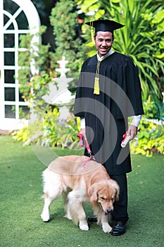 Happy asian man graduated holding and showing degree with his dog, idea for education concept