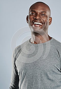 Happy man in gray shirt laughing