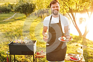 Happy man with grilled food and wine