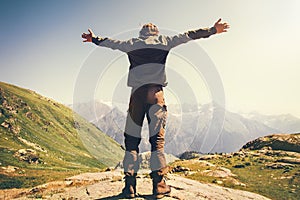 Happy Man hands raised mountaineering photo