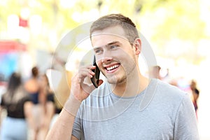 Happy man having a phone conversation