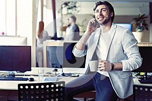 Happy man having talk and drinking coffee photo