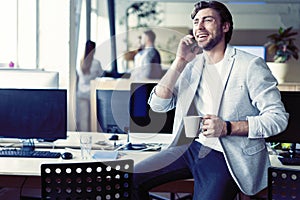 Happy man having talk and drinking coffee photo