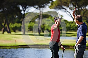 Happy man, high five and celebration with golf course for winning, point or score in outdoor nature. Male person