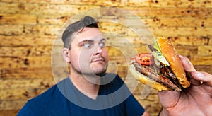 Happy man with his fast food burger. Not so much healthy life style, but whatever