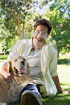 Happy man with his pet dog in park