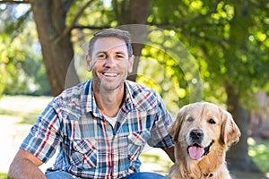 Happy man with his pet dog in park