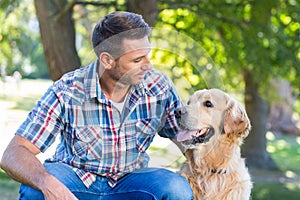 Happy man with his pet dog in park