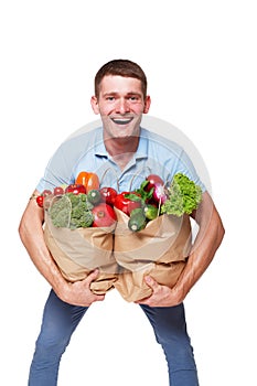 Happy man hold bags with healthy food, grocery buyer isolated