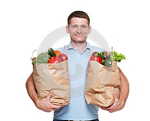 Happy man hold bags with healthy food, grocery buyer isolated