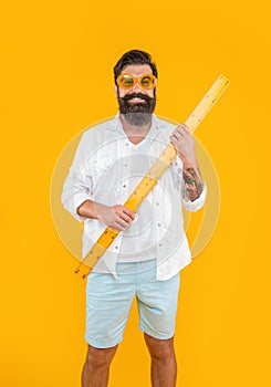 happy man hold measuring ruler in studio. man hold measuring ruler on background.