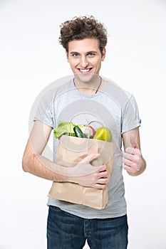 Happy man holding a bag of groceries