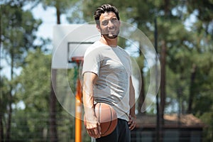 happy man holding basketball