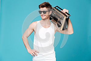 Happy man holding tape recorder