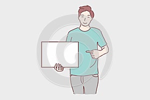 Happy man holding white blank banner and pointing at a copy space