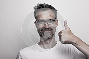 Happy man holds one thumb up photo