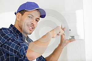 happy man installing electric hand-dryer