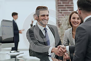 Happy man introducing businesswoman to business partners