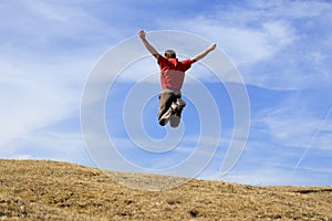 Happy man is jumping in the air