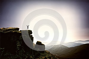 Happy man jumping for joy on the peak of the mountain. Success