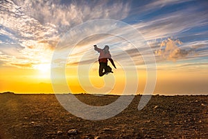 Happy man jumping for joy at sunset. Success, winner, happiness, ttavel concept