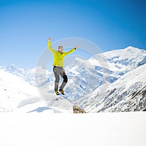 Happy man jumping in mountains