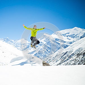 Happy man jumping success in mountains