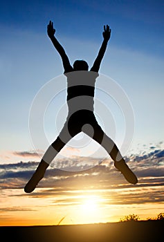 Happy Man jumping at Sunset