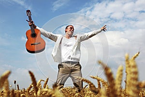 Happy man jumping in a wheat field