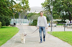 Happy man with labrador dog walking in city