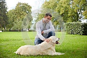 Happy man with labrador dog walking in city