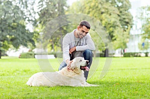 Happy man with labrador dog walking in city