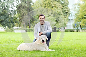 Happy man with labrador dog walking in city