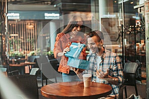 Happy man and lady watching at gift