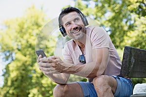 Happy man listen to music in park