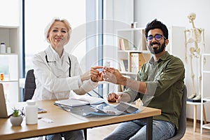 Happy man listening attentively to recommendations regarding medical history.