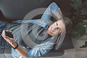 Happy man listening music at home