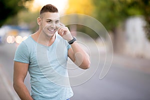 Happy man making call on city street