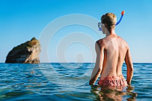 Happy man with mask for snorkling at the seaside beach on summer vacation