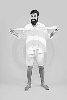 happy man with measuring ruler isolated on yellow. man with measuring ruler in studio.