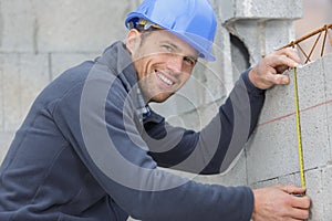 happy man measuring wall