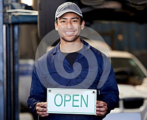Happy, man and mechanic with open sign in car workshop for welcome, vehicle repairs and expert advice. Smile, male