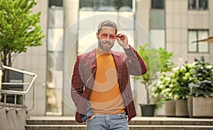 happy man in menswear outside. photo of man in menswear of jacket. photo