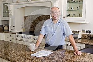 Happy man in modern kitchen
