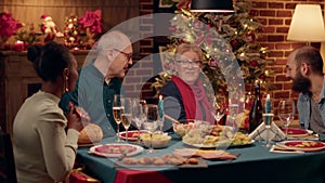 Happy man offering gift to young woman while celebrating winter holiday