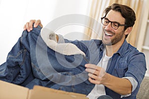 Happy man opening cardboard box package